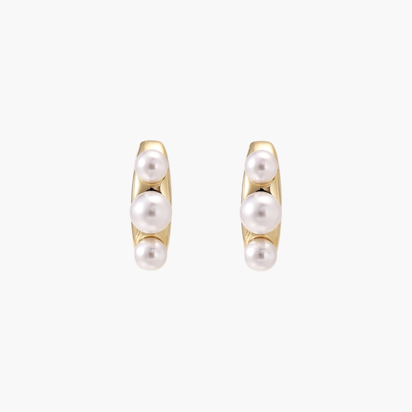 14K gold-plated curved stud earrings with three white freshwater pearls aligned vertically on cream background