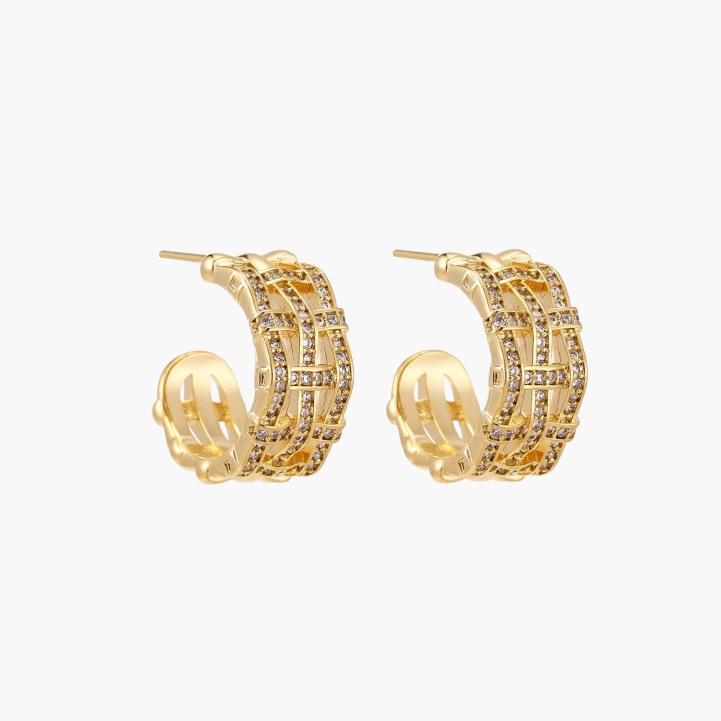 Gold-plated geometric hoop earrings with basket-weave lattice design and pavé crystal accents on cream background